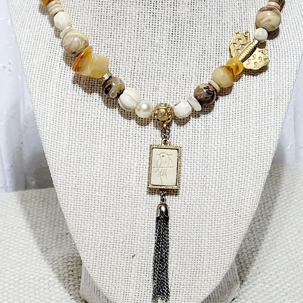 Silver and Gold Tone Necklace with a Bird, Butterfly and Beads.
